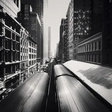 Wabash in Chicago: Metro train passing by modern buildings.