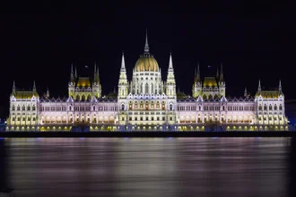 Night photo of the Hungarian Parliament Building in Budapest, gentle light reflections on the water
