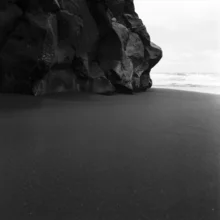 Black-and-white photo art: serene black sand landscape in Spain