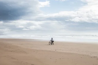 Beautiful image of a bike on the beach under the clear sky in Morocco.