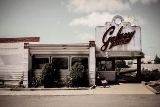 Photo art by Florian Paulus: empty diner beneath a galaxy sky