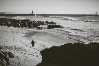 Black and white photo art: walking on the beach in Portugal with gentle shadows.
