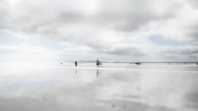 Photo art by Rob van Kessel: Surfer reflected in the water of Cape Town.