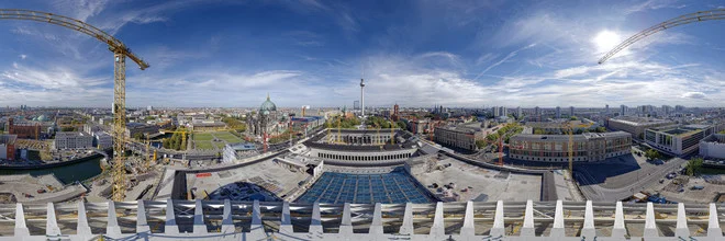 Panoramic view of the Berlin Palace with dome and cranes in the foreground.