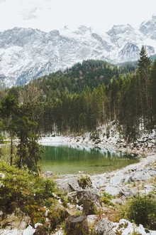 Photo art by Thomas Richter: tranquil mountain lake surrounded by snowy Alps