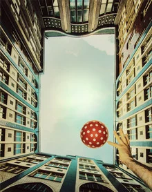 Playfulness: colorful polka dots and fluffy clouds under a clear sky.