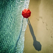 Photo art: an umbrella on the beach, gentle waves and sunshine in the background.