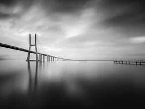 Black and white photo of the Vasco da Gama Bridge in Lisbon, conveying a calm mood.