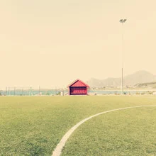 Photo art by Franz Sussbauer: football field in Lofoten with a green cabin
