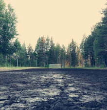 Wall art by Franz Sussbauer: Muddy soccer match in Sweden, featuring teamwork and enjoyment.