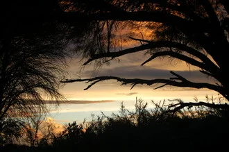 Photo art by Fritz Kleemann: wooden window framing the evening sky in Namibia