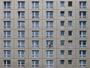 Photo art by Klaus Lenzen: facade of a panel building with windows and a satellite dish.