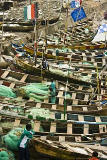 Photo art by Antonia Bartning: fishermen at work in a harbor in Ghana.