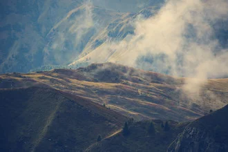 Photo art by Franz Sussbauer: clouds over a green hilly landscape in South Tyrol.