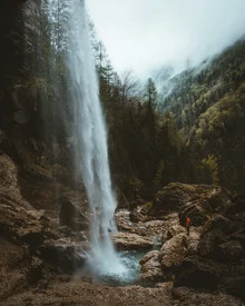 Photo art: gentle autumn mood with waterfall in a misty Slovenian forest