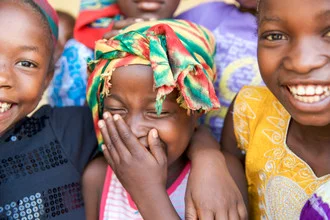 Photo art: smiling girls from Sierra Leone radiating joy