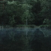 Morning mood in Furlbachtal with calm water and gentle light reflections.
