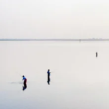 Photo art by Nina Papiorek: fishermen on Inle Lake at sunset
