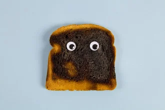 Photo art by Loulou von Glup: burned bread on a white background