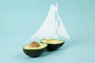 Quirky photo art of an avocado sailboat creating a cheerful atmosphere.