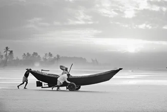 Photo art by Jakob Berr: fishermen launching their boat in the morning in Bangladesh.