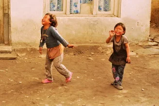 Joyful laughter of children in Nepal radiating happiness and carefree spirit.