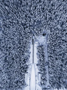 Aerial view of a ski jumping hill in winter, capturing the essence of the sport