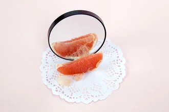 Wall art depicting the intimacy of a peeled grapefruit in soft colors.