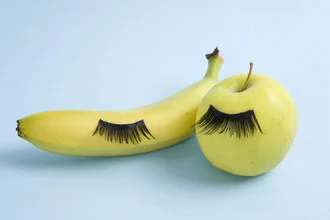 Photo art featuring fruit eyelashes in a whimsical still life composition