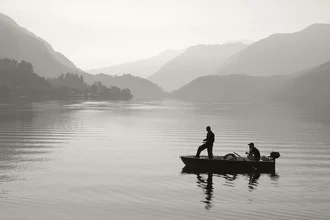 Fisherman at the mountain lake: tranquil, picturesque scene in black and white