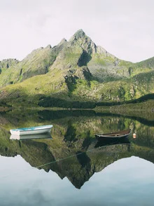 Calm morning in Norway: mountains reflect in still water