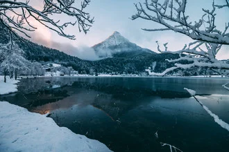 Winter reflection of a lake in the Tyrolean mountains