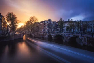 Sunset in Amsterdam, calm clouds over the canals, soft colors in the evening sky