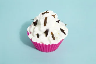 Wall art: playful cupcake with cream and colorful sprinkles on a pink background