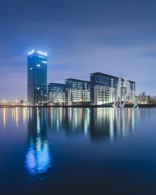 Berlin Osthafen at dusk with Molecule Men and soft light reflections on the water