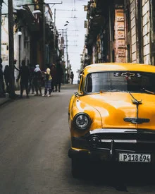 Photo art by Dimitri Luft: vibrant view of a vintage yellow car in Havana.