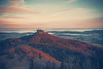 Photo art by Franz Sussbauer: Hohenzollern Castle in morning light over gentle hills.