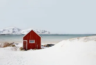 Charming winter scene with a cabin by the sea in Norway.