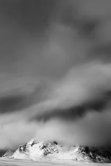 Black and white photo art: striking cloud formations over snow-covered mountains in Norway