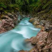 Mountain stream surrounded by gentle alpine hills, creating a calming atmosphere.