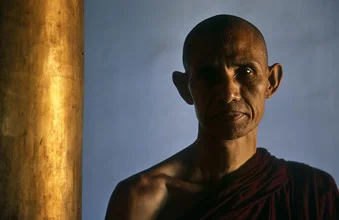 Meditative monk in Myeik, soft sidelight creates tranquility and calmness.