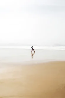 Wall art of a lone surfer riding gentle ocean waves