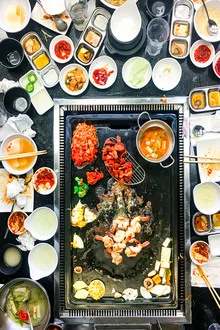 Photo of a Korean BBQ plate with fresh ingredients and grilling utensils