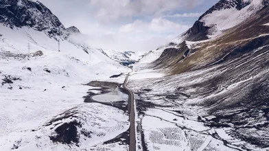 Aerial view of a snow-covered road in the Swiss Alps