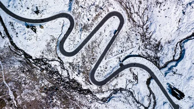 Photo art by Rémi Peschet: winding road through Swiss mountains