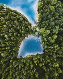 Bird's-eye view of Lake Eibsee in the Alps, calm water and surrounding nature