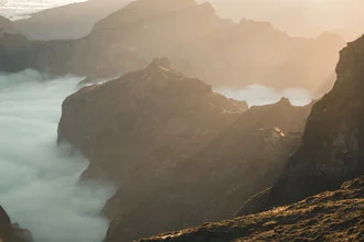 Photo art: Human figure in a valley, surrounded by sunlight and clouds