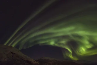 Photo art by Dirk Heckmann: winter landscape with northern lights and snow-covered ground