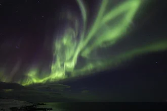 Intense northern lights over the Lofoten in Norway, cold night with twinkling stars