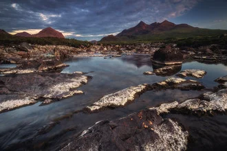 Waterfall in Scotland: tranquil scenery with the Black Cuillin in the background.